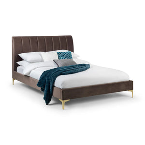 Bed with brown upholstered headboard and white bedding on a white background