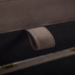 Close-up of a brown leather handle on a suitcase.