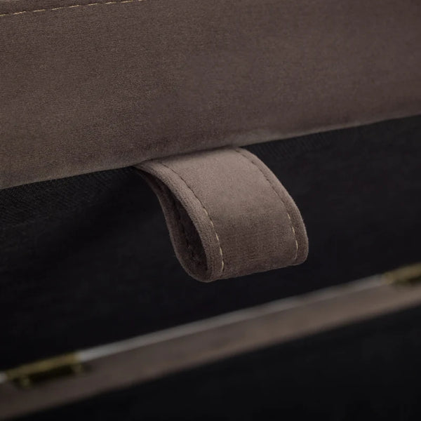 Close-up of a brown leather handle on a suitcase.