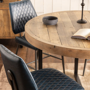 Black leather chair with quilted pattern on a wooden floor