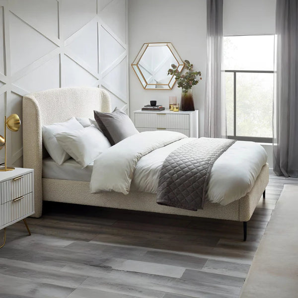 Modern bedroom with a bed, nightstands, and decorative elements.