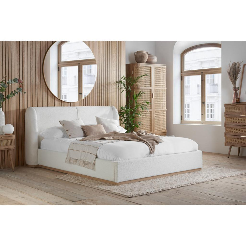 White bed frame with a mattress on a white background