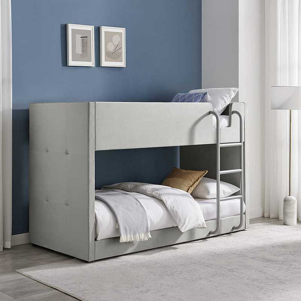 Gray bunk bed in a room with blue walls and framed pictures.