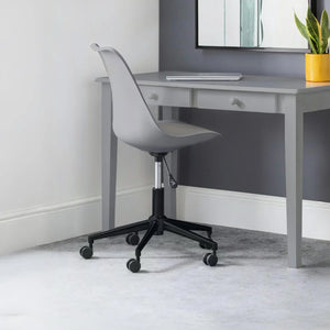 Gray office desk with a chair in a room with a plant and mirror.