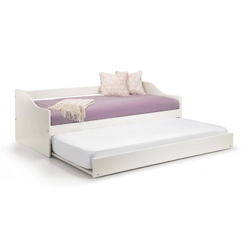 White bed with a purple mattress and decorative pillows on a white background