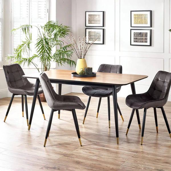 Dining room with a wooden table and gray chairs on a wooden floor.