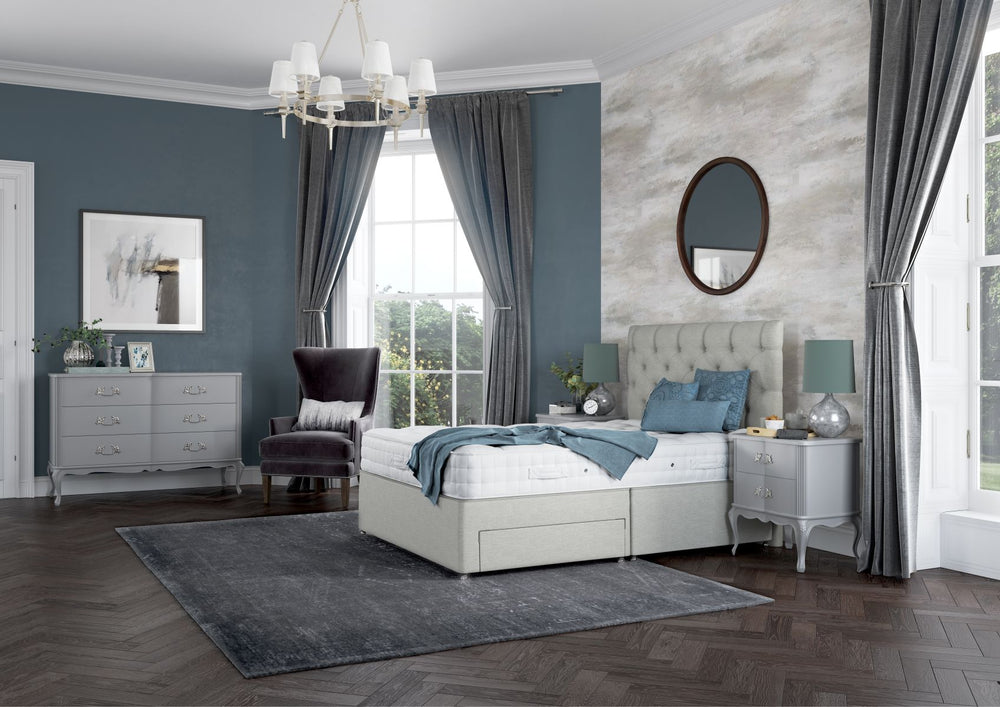 Gray upholstered bed with tufted headboard on a white background