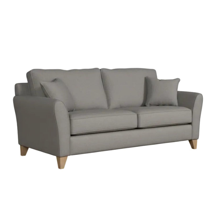 grey sofa with two cushions on a white background