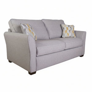 Gray sofa with patterned cushions on a white background