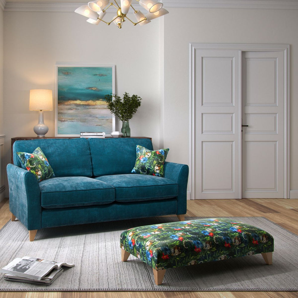 Gray sofa with patterned cushions on a white background