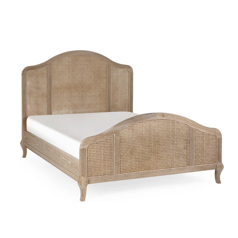 Wicker bed frame with white mattress on a white background