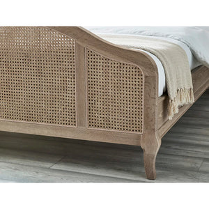 Wooden bed with rattan design on a wooden floor