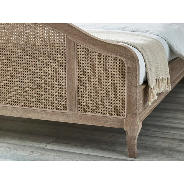 Wooden bed with rattan design on a wooden floor
