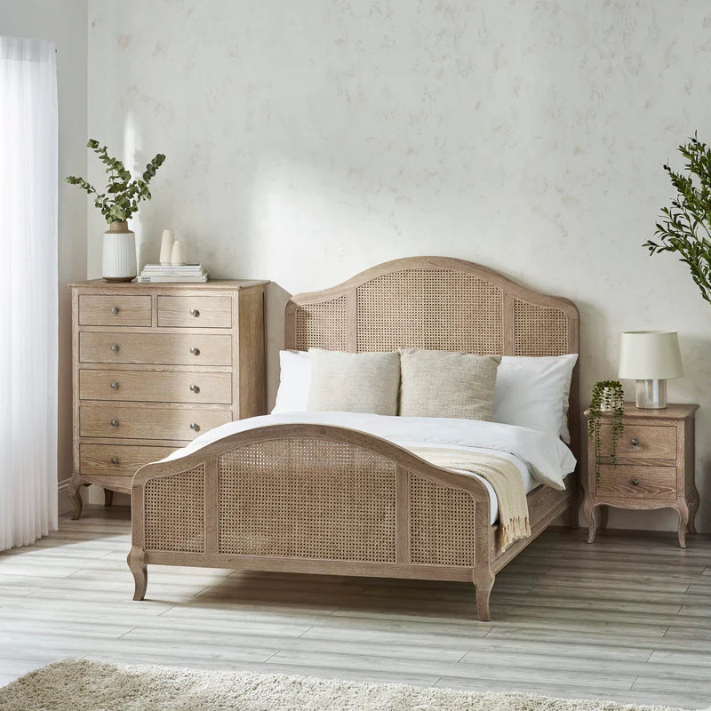 Wicker bed frame with white mattress on a white background