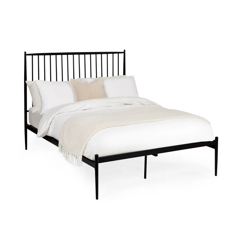 Black metal bed frame with white bedding on a white background