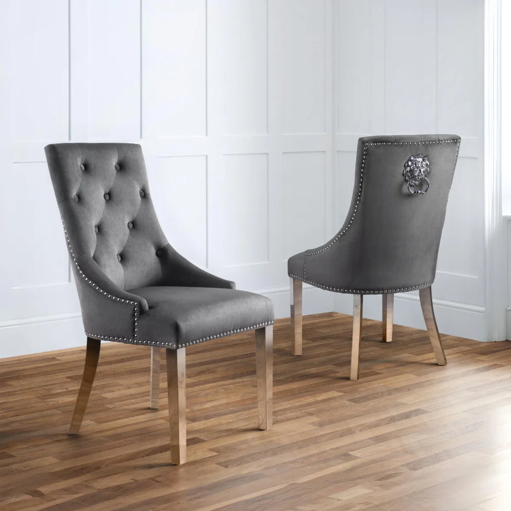 Two gray upholstered chairs with silver legs on a white background