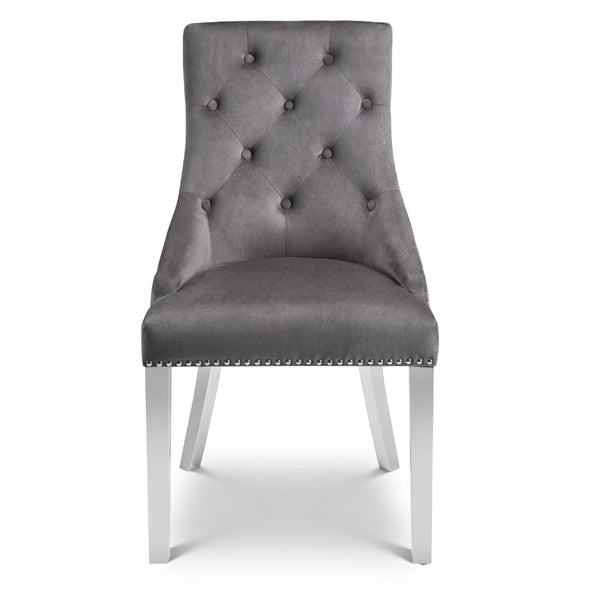 Gray upholstered chair with tufted backrest on a white background