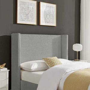 Bedroom with a gray upholstered headboard, white bedding, and decorative pillows.