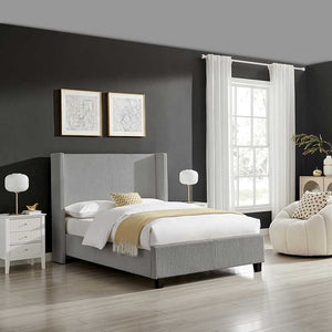 Modern bedroom with gray upholstered bed, white nightstands, and a window with white curtains.
