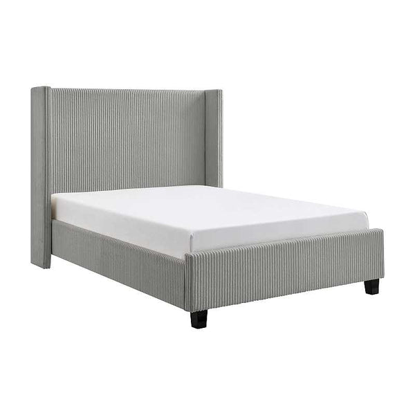 Gray upholstered bed with white mattress on a white background