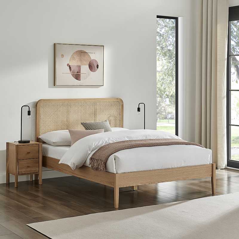 Wooden bed frame with woven headboard and white mattress on a white background