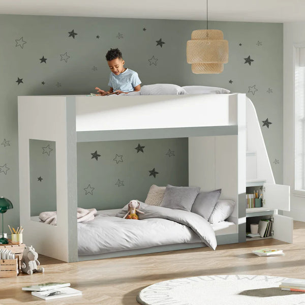 Children's room with a white loft bed and gray lower bed, decorated with star decals on the wall.