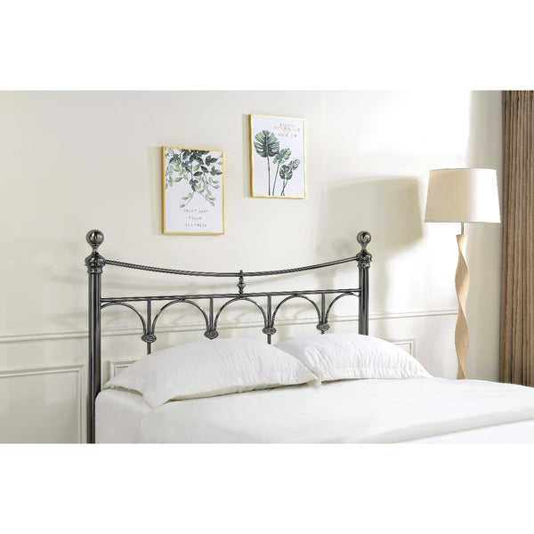 Metal headboard with white bedding in a bedroom setting