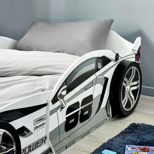 Children's race car bed with open door in a bedroom setting