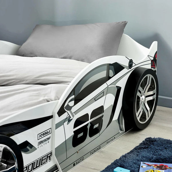 Children's race car bed with open door in a bedroom setting