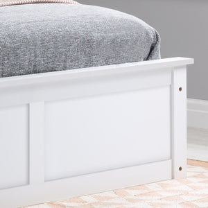 White wooden bed frame with a gray bedding against a gray wall.
