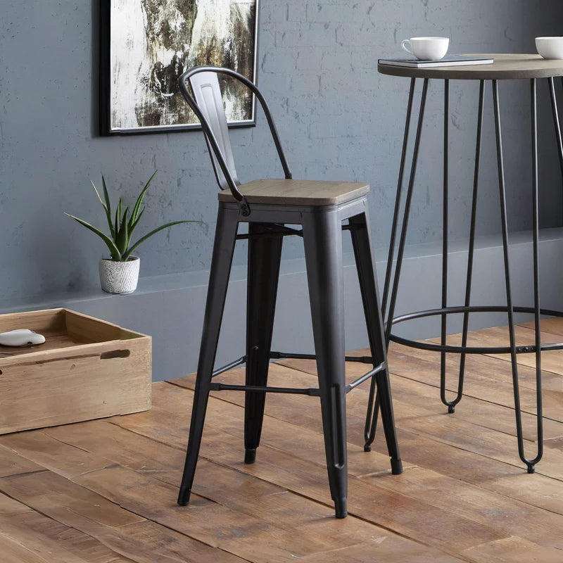 Two black metal bar stools with wooden seats on a white background