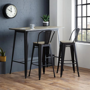 High table with bar stools in a modern room with a clock on the wall.