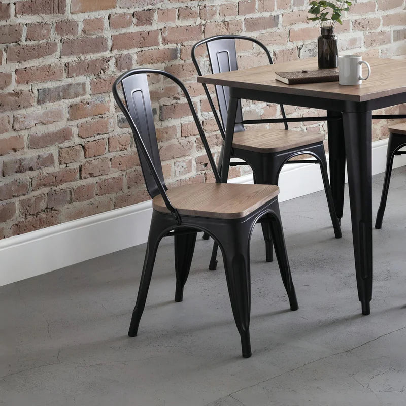 Four black metal chairs with wooden seats on a white background