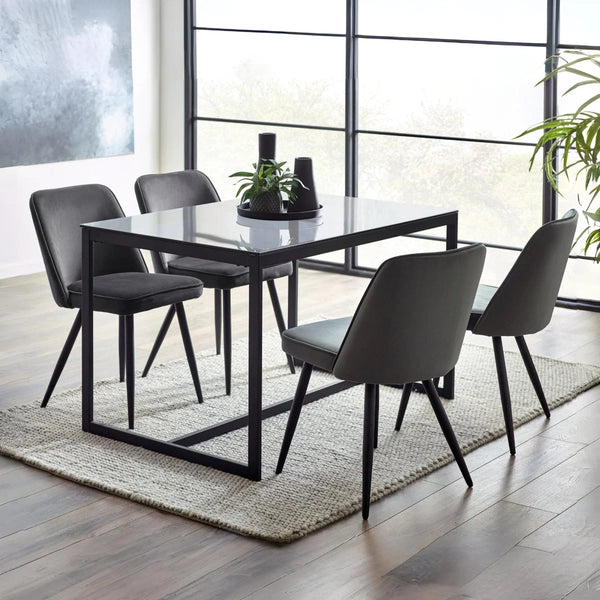 Dining room with a black rectangular table and four GREY matching chairs on a wooden floor.