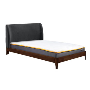 Bed with grey upholstered headboard and wooden frame on a white background