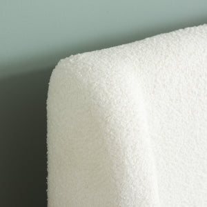 Close-up of atextured white headbaord wrap against a light gray background