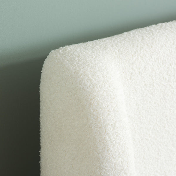 Close-up of atextured white headbaord wrap against a light gray background
