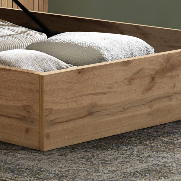 Wooden bed frame with pillows on a textured floor
