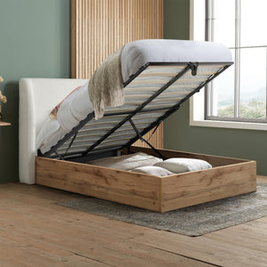 Wooden bed with storage compartment in a room with a window and rug.