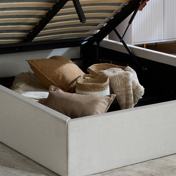 Beige bed with striped canopy and decorative pillows and baskets.