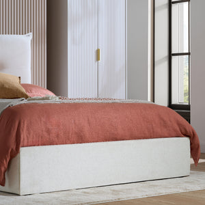 Bed with pink bedding in a modern bedroom setting