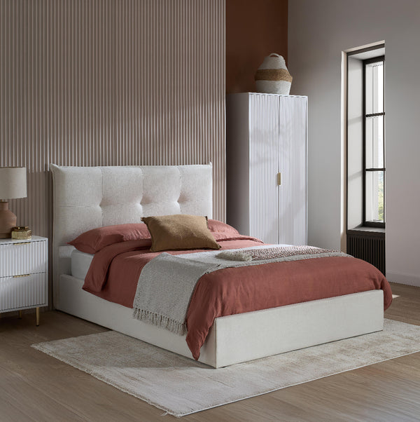 Modern bedroom with a bed, wardrobe, and side table.