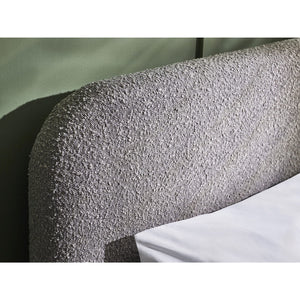 Textured headboard with a white pillow on a neutral background