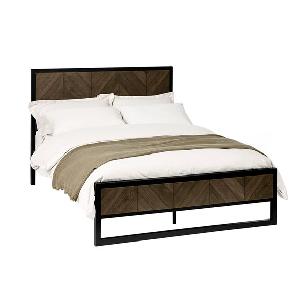 Bed with wooden headboard and metal frame on a white background