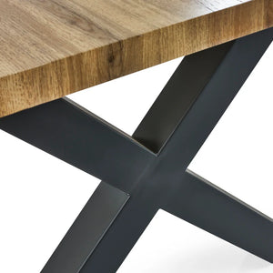 Close-up of a wooden table with a black metal base on a white background