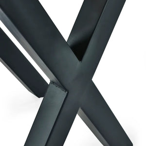 Close-up of a black metal 'X' frame on a white background