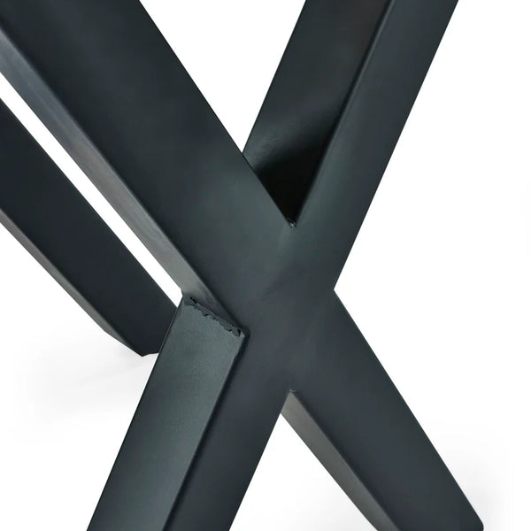 Close-up of a black metal 'X' frame on a white background