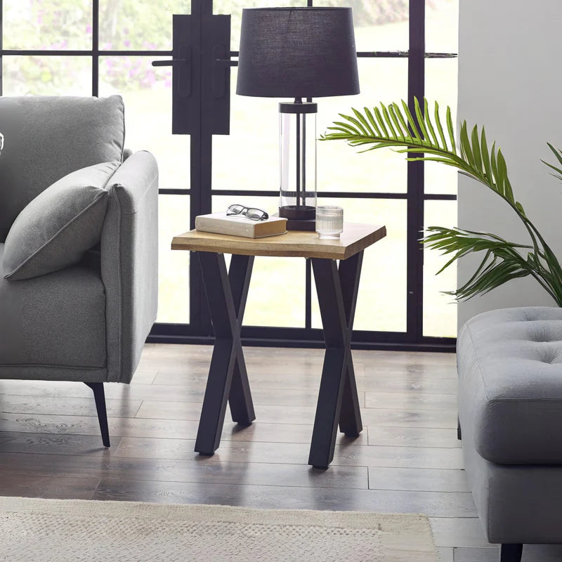 Small wooden table with black metal legs on a white background