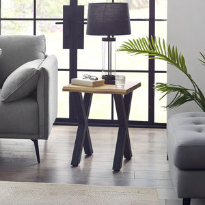 Modern living room with a side table, lamp, and gray sofa.
