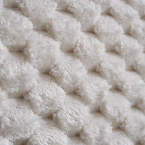 Close-up of a textured beige fabric surface